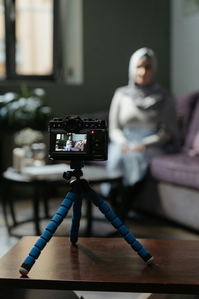 Camera on tripod recording a woman